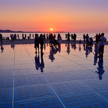 Sunset in Zadar...Greetings to the sun is an art installation located in the port of Zadar, on the western point of the Zadar peninsula. It is overlooking the city harbor, islands and famous Zadar sunset...The Greetings to sun uses solar power to create a light show that displays at night. After sunset the lighting elements are activated installed in the circuit, and following a particularly programmed scenario, they produce very impressive show of light.