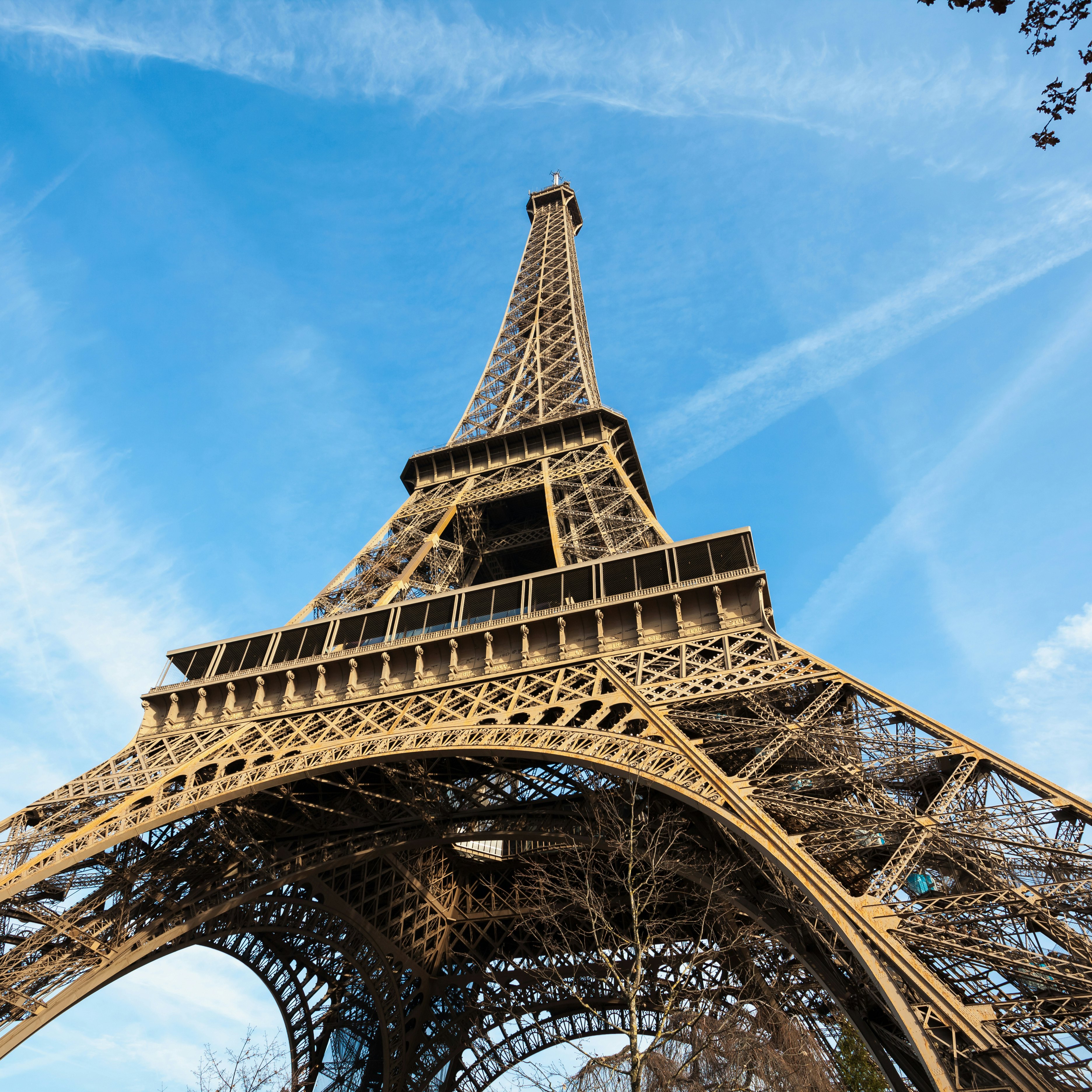 Wide shot of Eiffel Tower with blue sky, Paris, France.