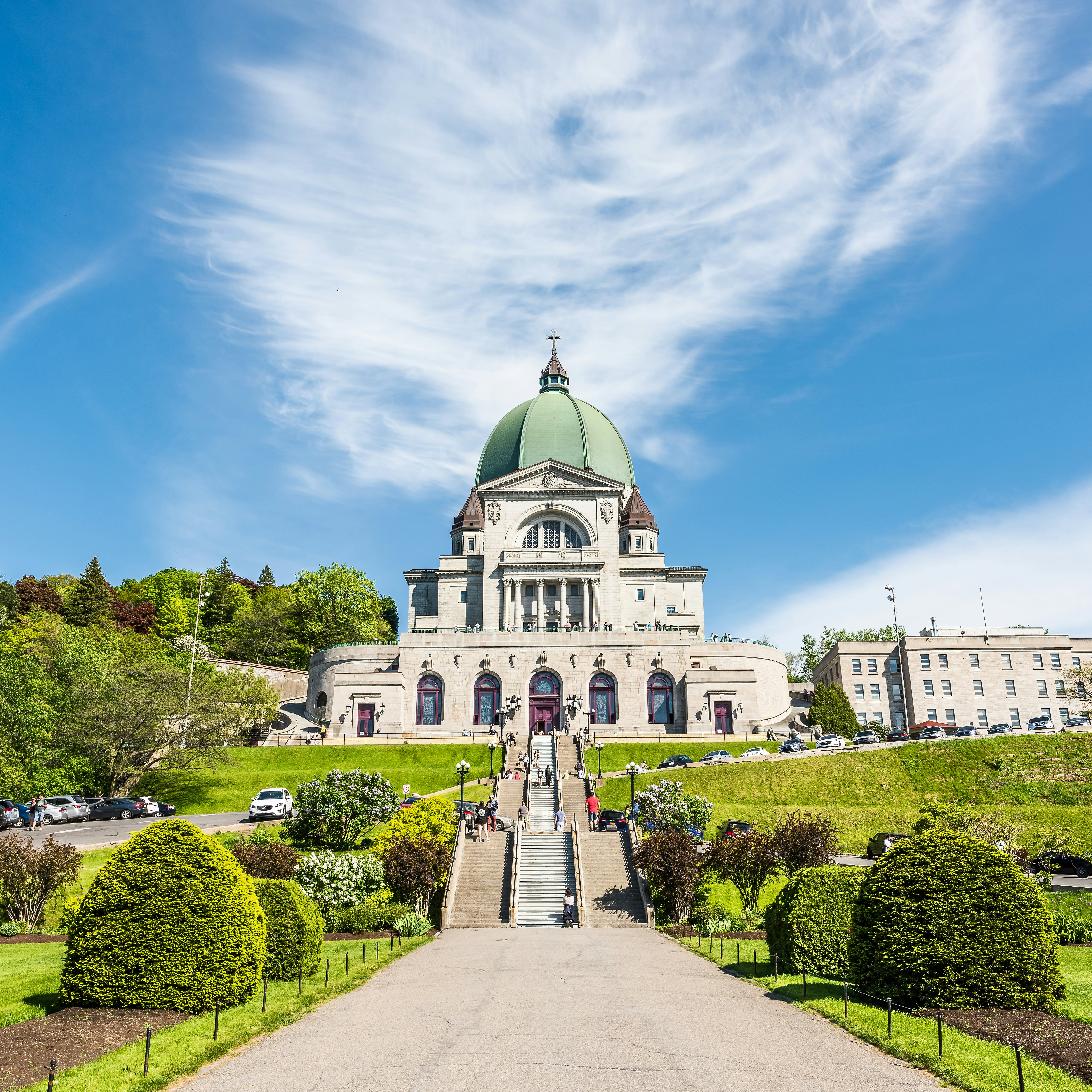 May 28, 2017: St Joseph's Oratory on Mont Royal with a woman praying on steps.